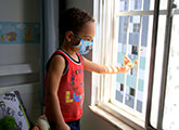 Child in Salvador wears protective face mask during COVID-19 pandemic
